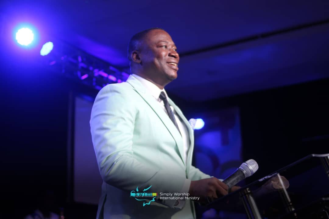Rev. Victor Atenaga addressing an audience on mic