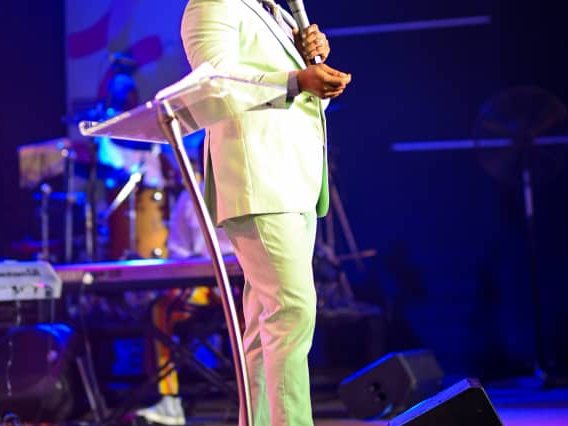 Rev. Victor Atenaga on stage at a keynote