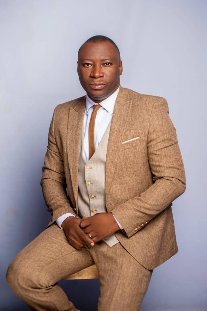 Rev. Victor Atenaga, seated portrait