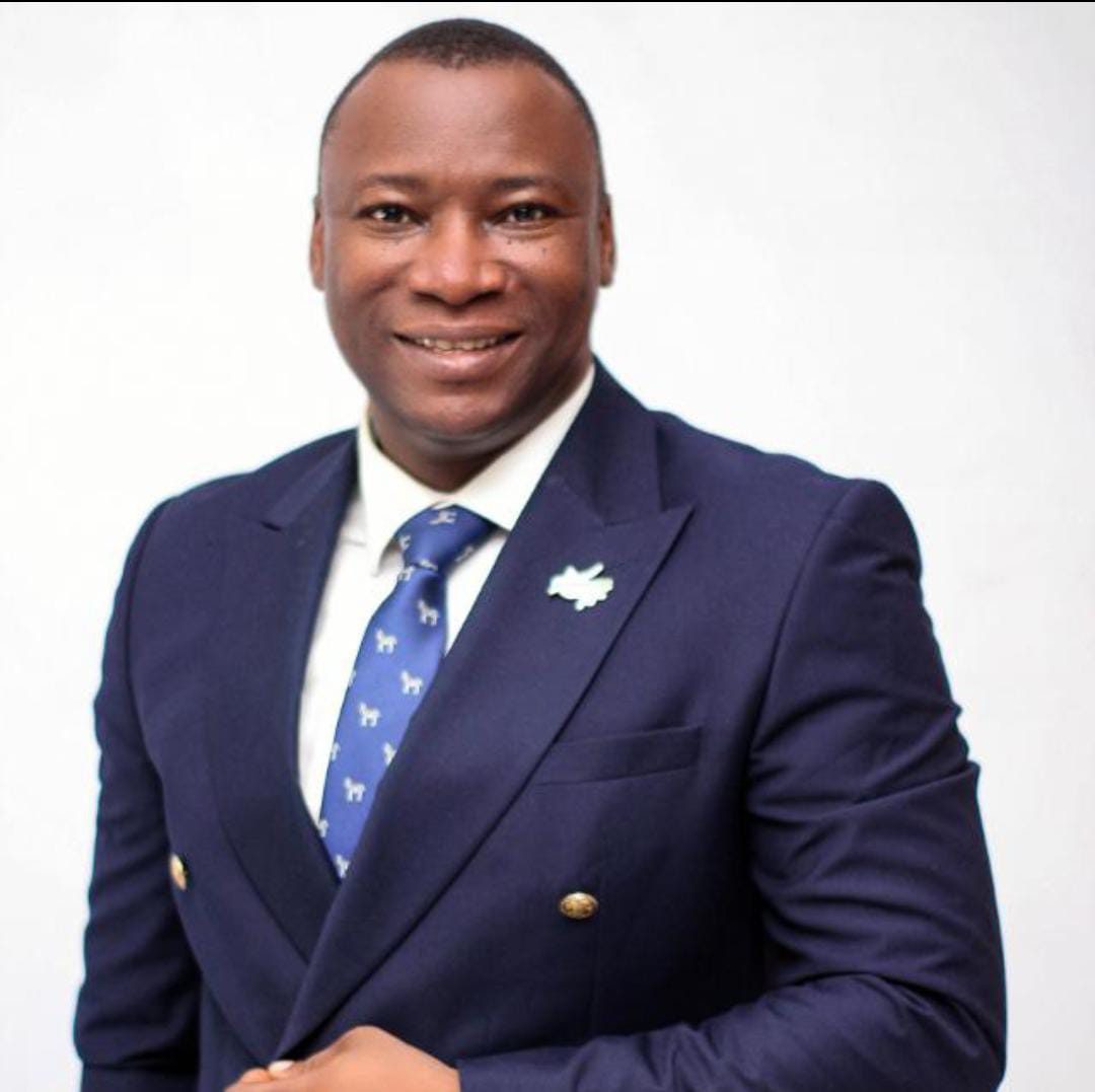 Rev. Victor Atenaga in a navy double-breasted suit
