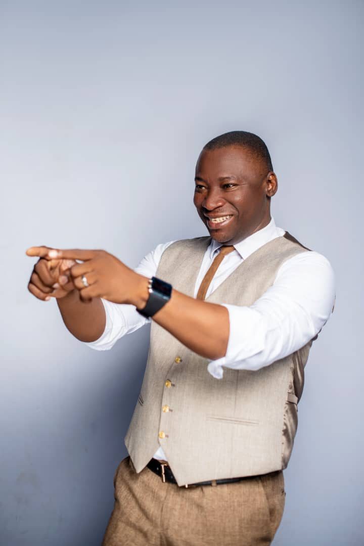 Rev. Victor Atenaga mid-gesture, coaching