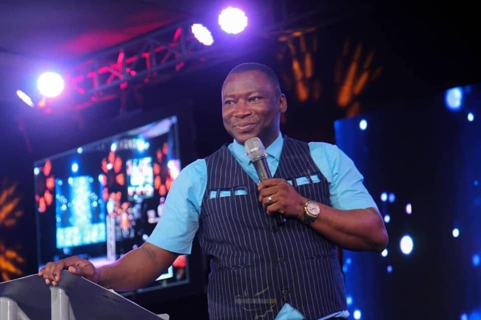 Rev. Victor Atenaga on mic at a lectern