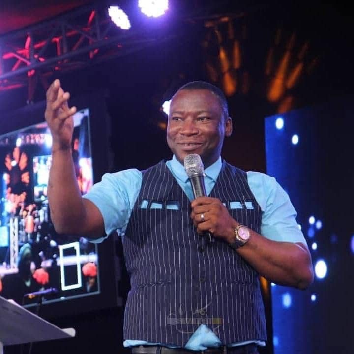 Rev. Victor Atenaga speaking on stage